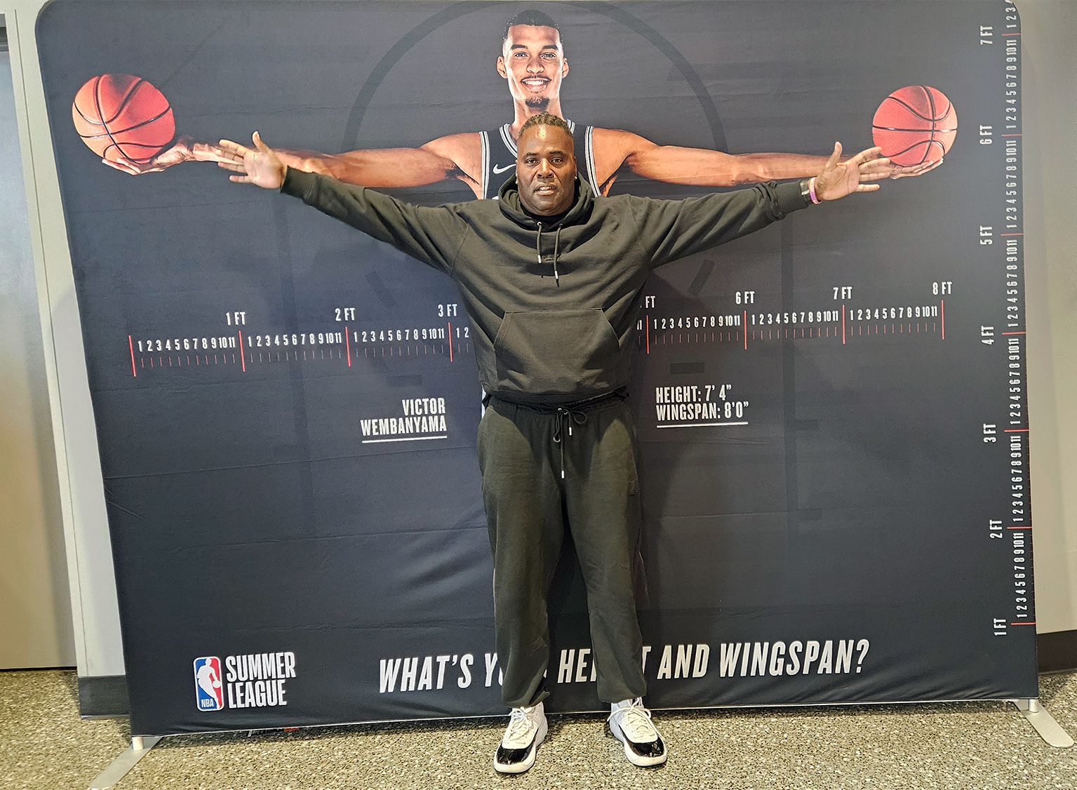 Coach Winn measuring his wingspan against Victor Wembanyama's at NBA Summer League, Las Vegas, 2026