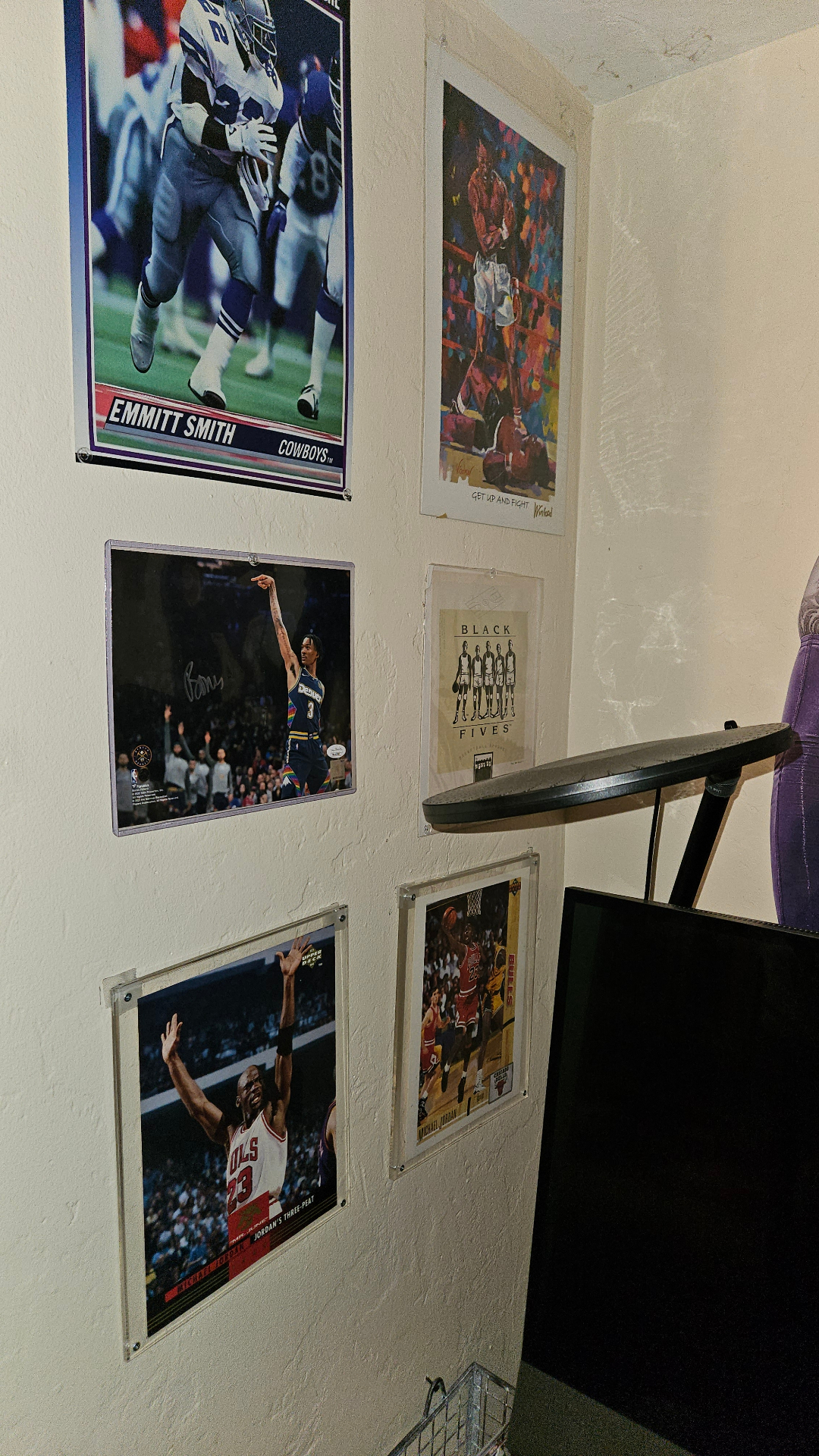 Left wall with sports prints and framed photography.
